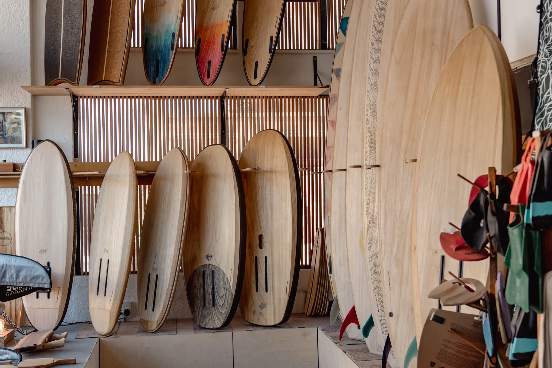 A wall of finished paulownia surfboards standing in the Wawa shop