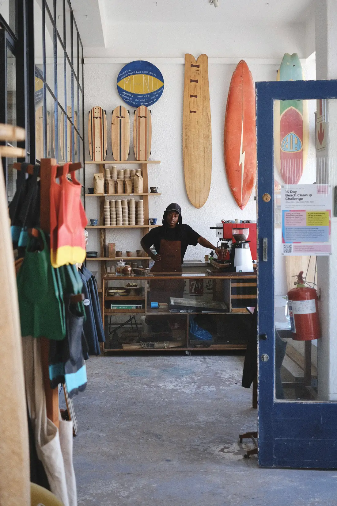Behind the counter at the Wawa cafe, boards and wetsuits either side